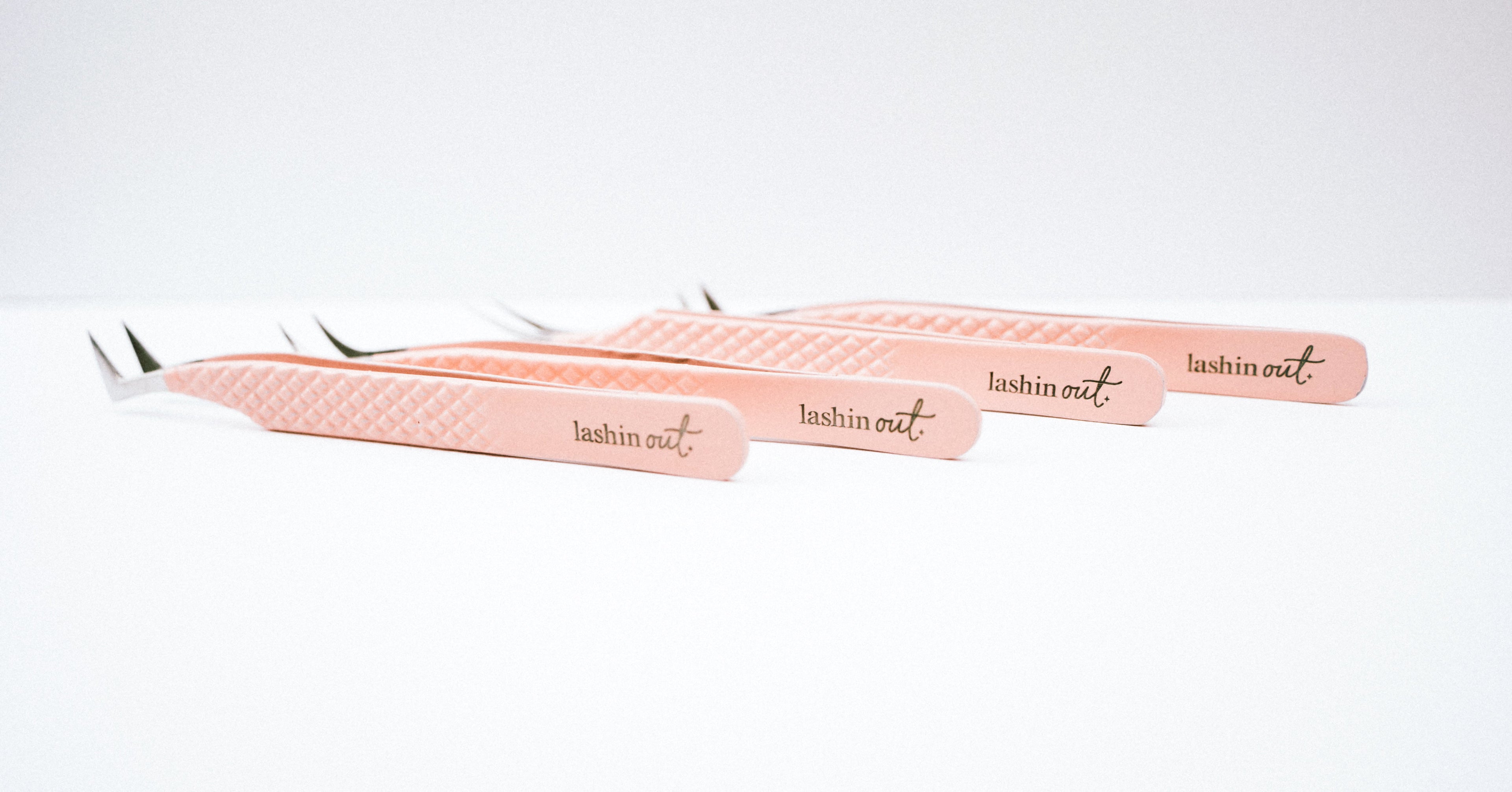 Four Blush Nano Tip Series tweezer in a row