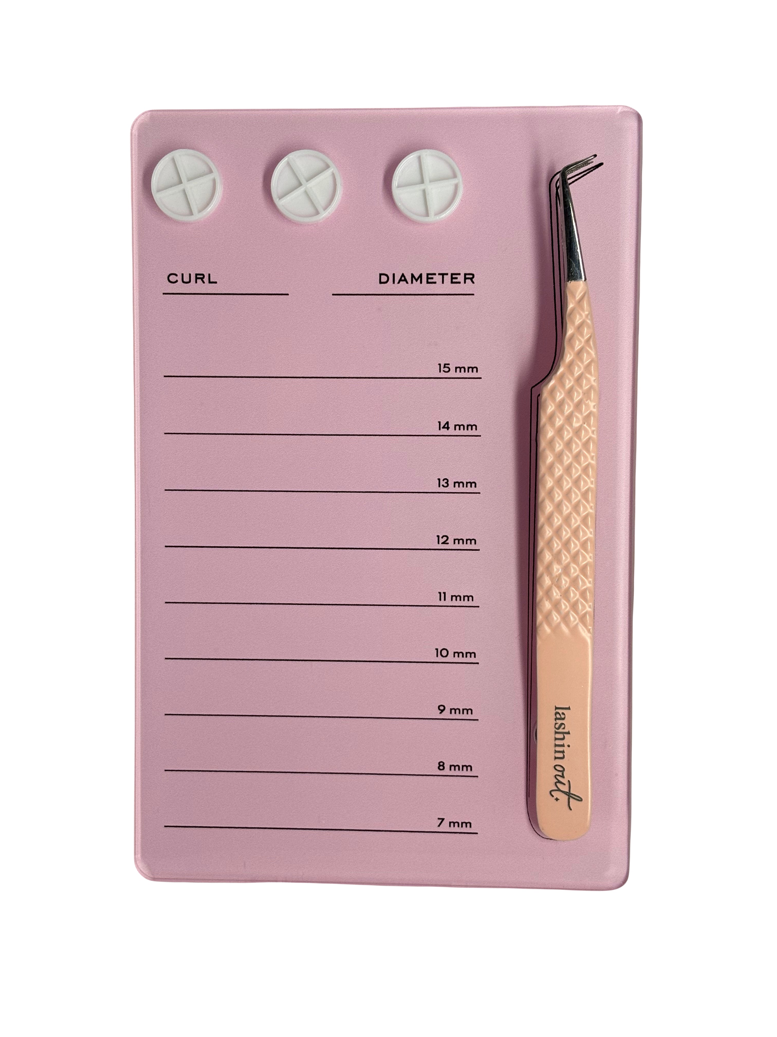A pink lash tile with three white glue cupholders at the top. Below the cup holders are the words Curl and Diameter. On the side, there is a pair of Lashin Out tweezers being held by two magnets. There are 9 horizontal lines going down the tile that indicate different millimetres to organize lash strips.
