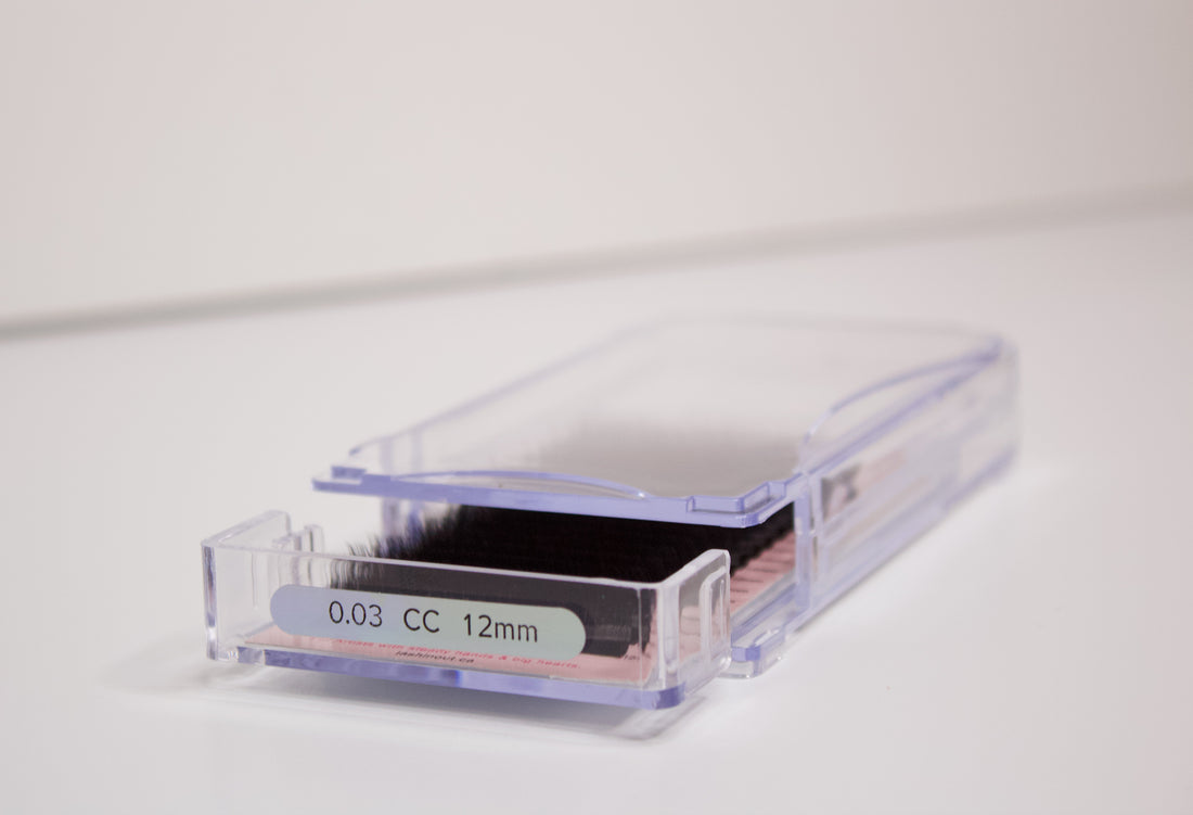 Volume lash extensions in a clear plastic tray. The tray says 0.03 CC 12 mm on the front.