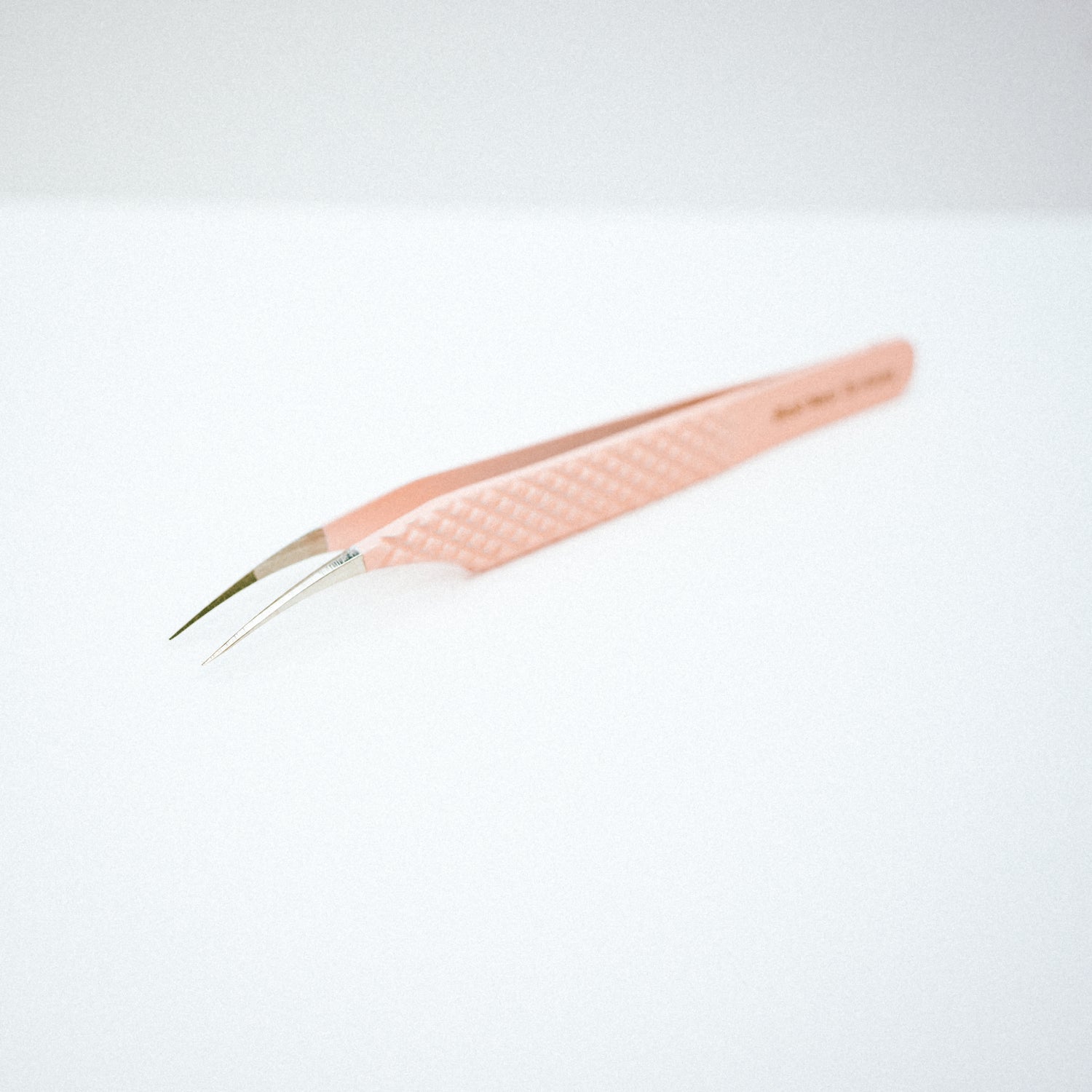 Font view of the Moon Curved Blush Nano Tip Lash Tweezer. The moon curved tips are pointing downwards.