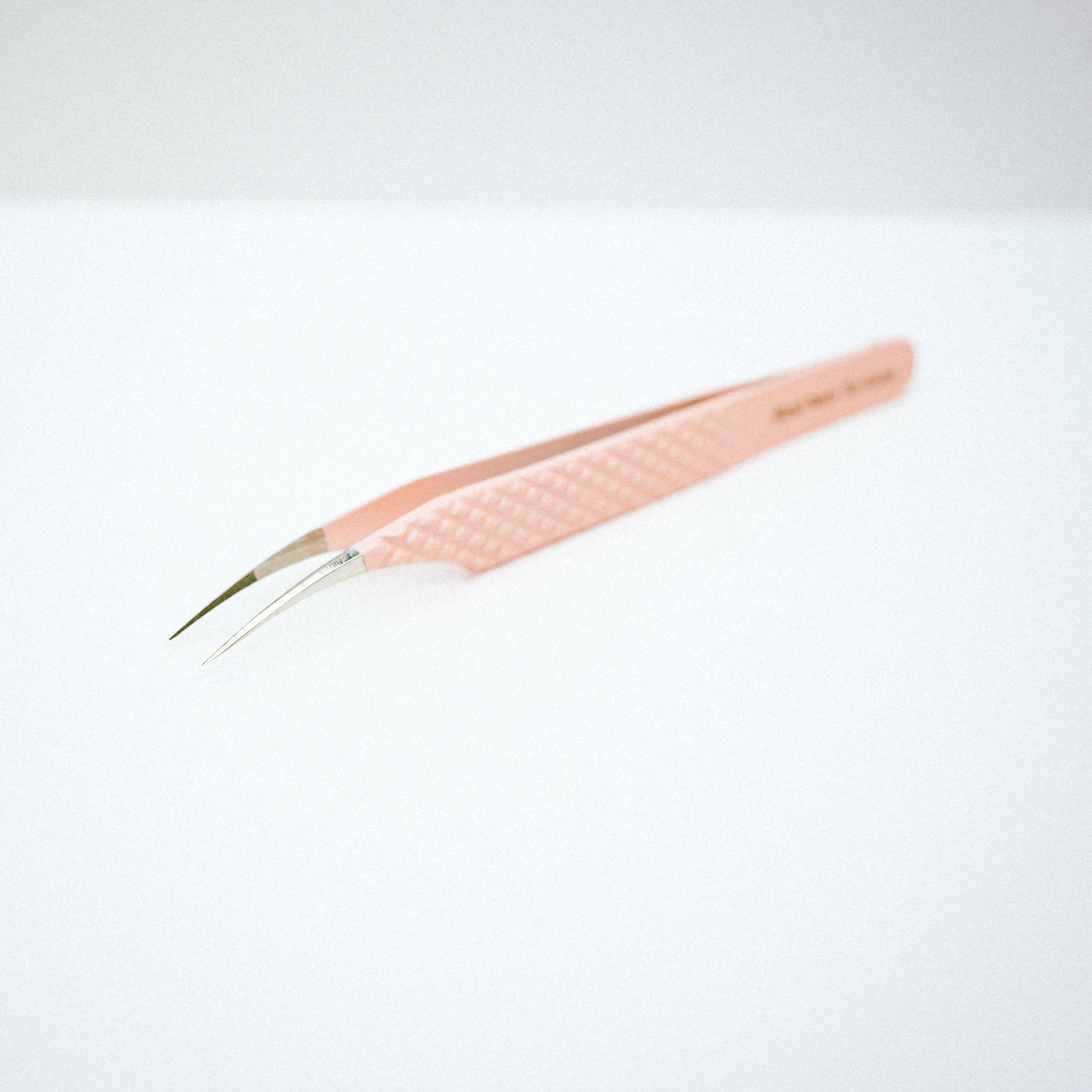 Font view of the Moon Curved Blush Nano Tip Lash Tweezer. The moon curved tips are pointing downwards.