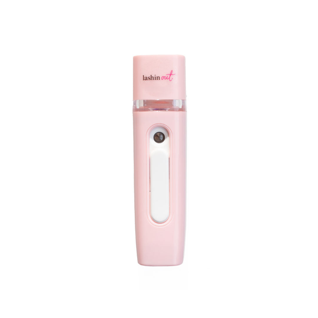 A front view of the pink nano mister. The words Lashin Out are written in black and pink at the top. The white slider is down and a black, round power button is visible.