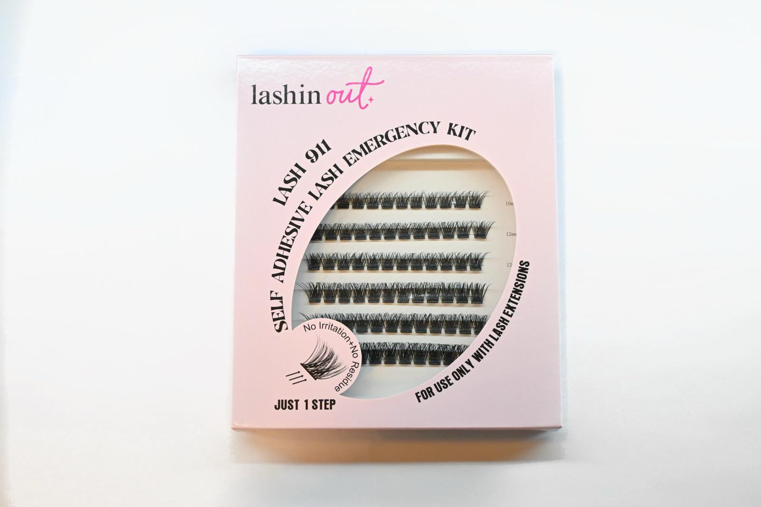 A box of Lashin Out Lash 911 lash clusters. The box is pink with a window in the front showing rows of lash clusters. 