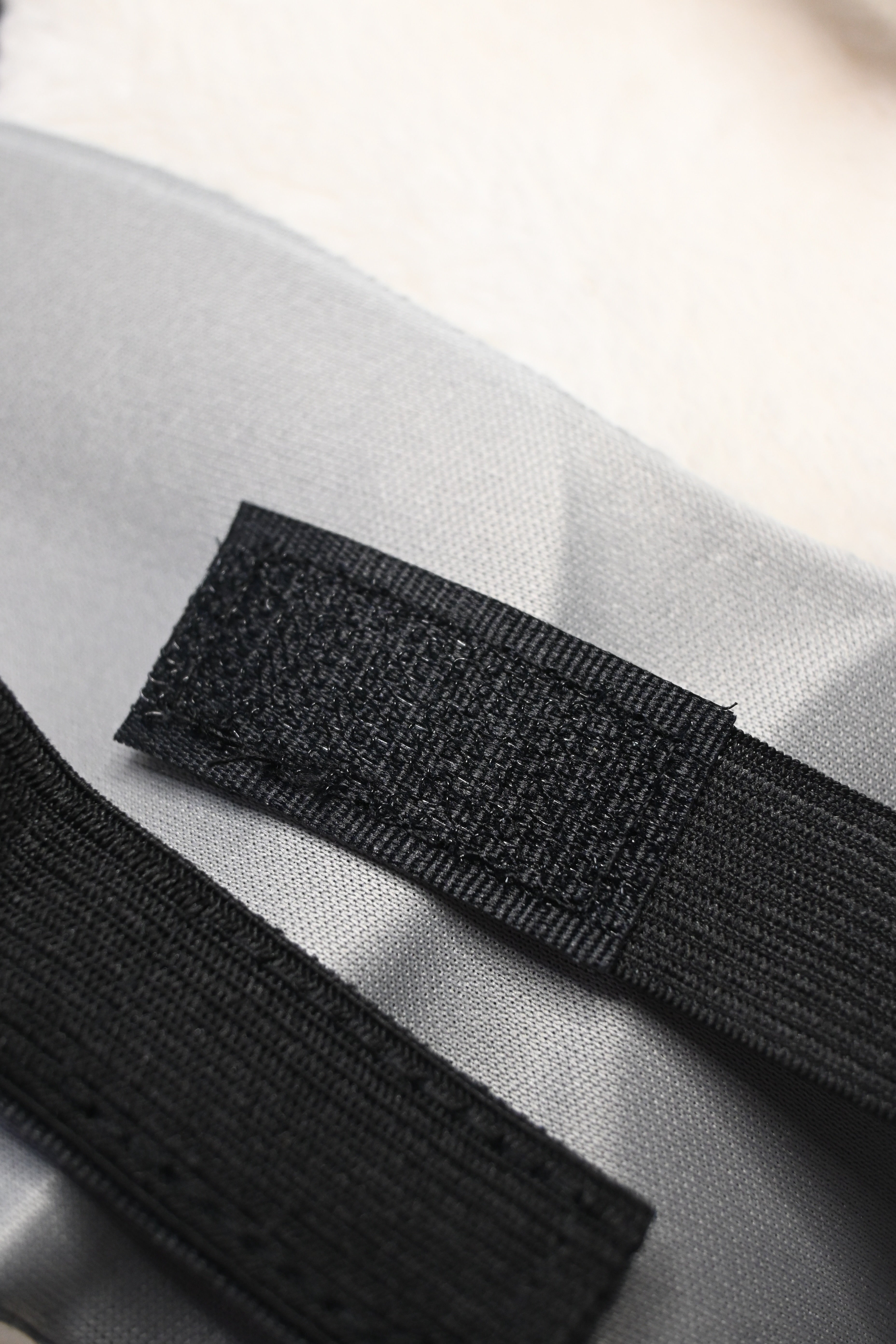 Velcro closure on a black elastic strap 