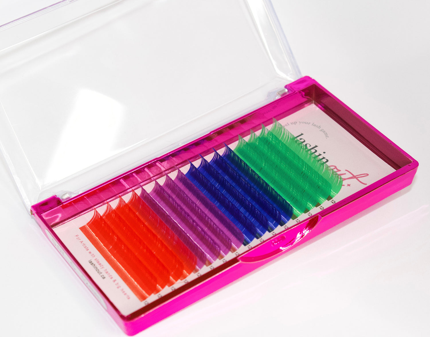 A tray of colored lashes. There are 4 rows of each color. From top to bottom the colors are green, dark blue, dark pink, red. 