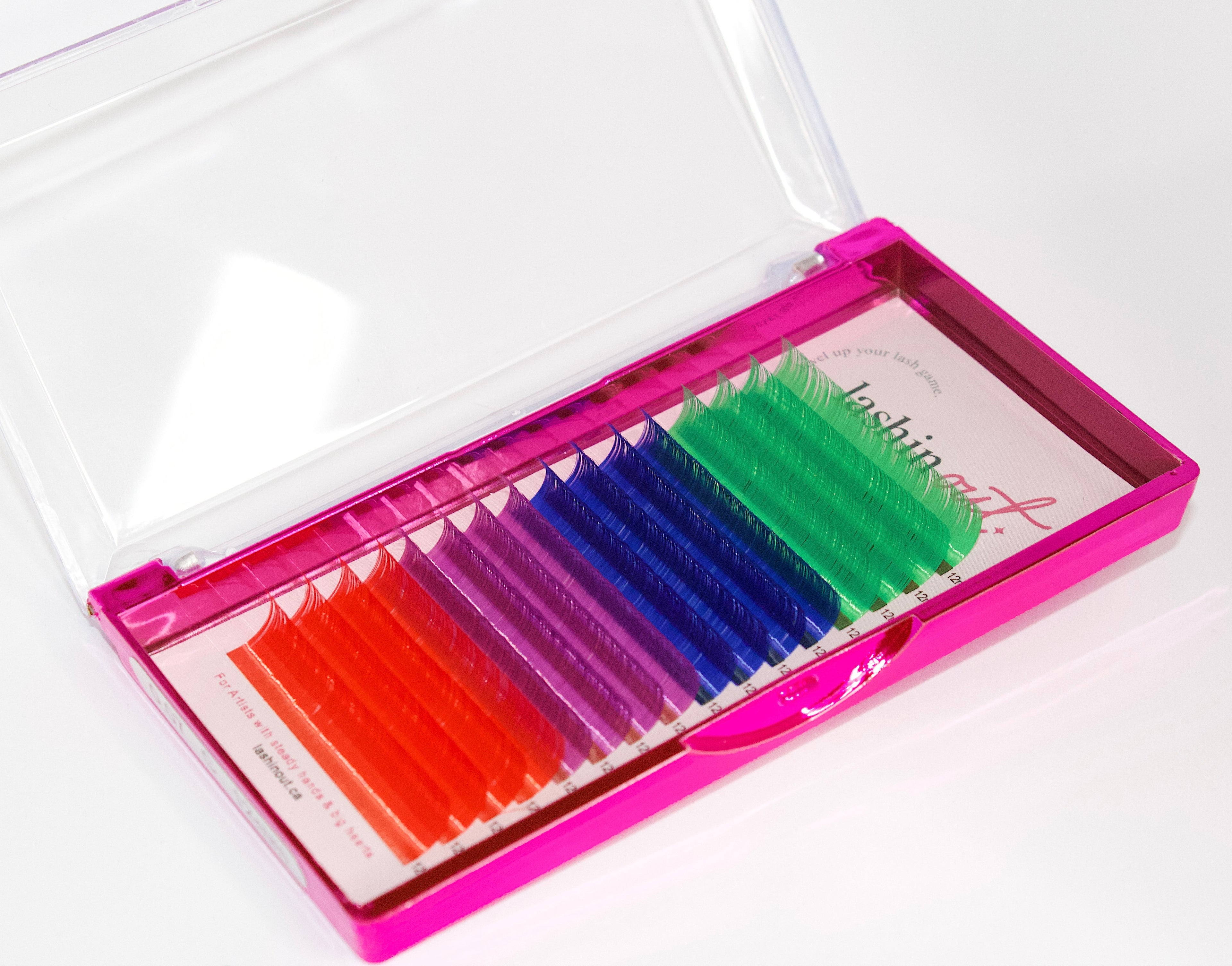 A tray of colored lashes. There are 4 rows of each color. From top to bottom the colors are green, dark blue, dark pink, red. 
