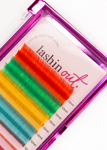 A tray of multicolored lashes. The colours are red, green, yellow, blue and pink. There are two lines of each colour. They are 12 mm lashes. 