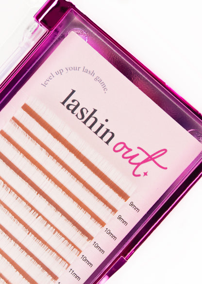 Top view of white lash extensions. The words &
