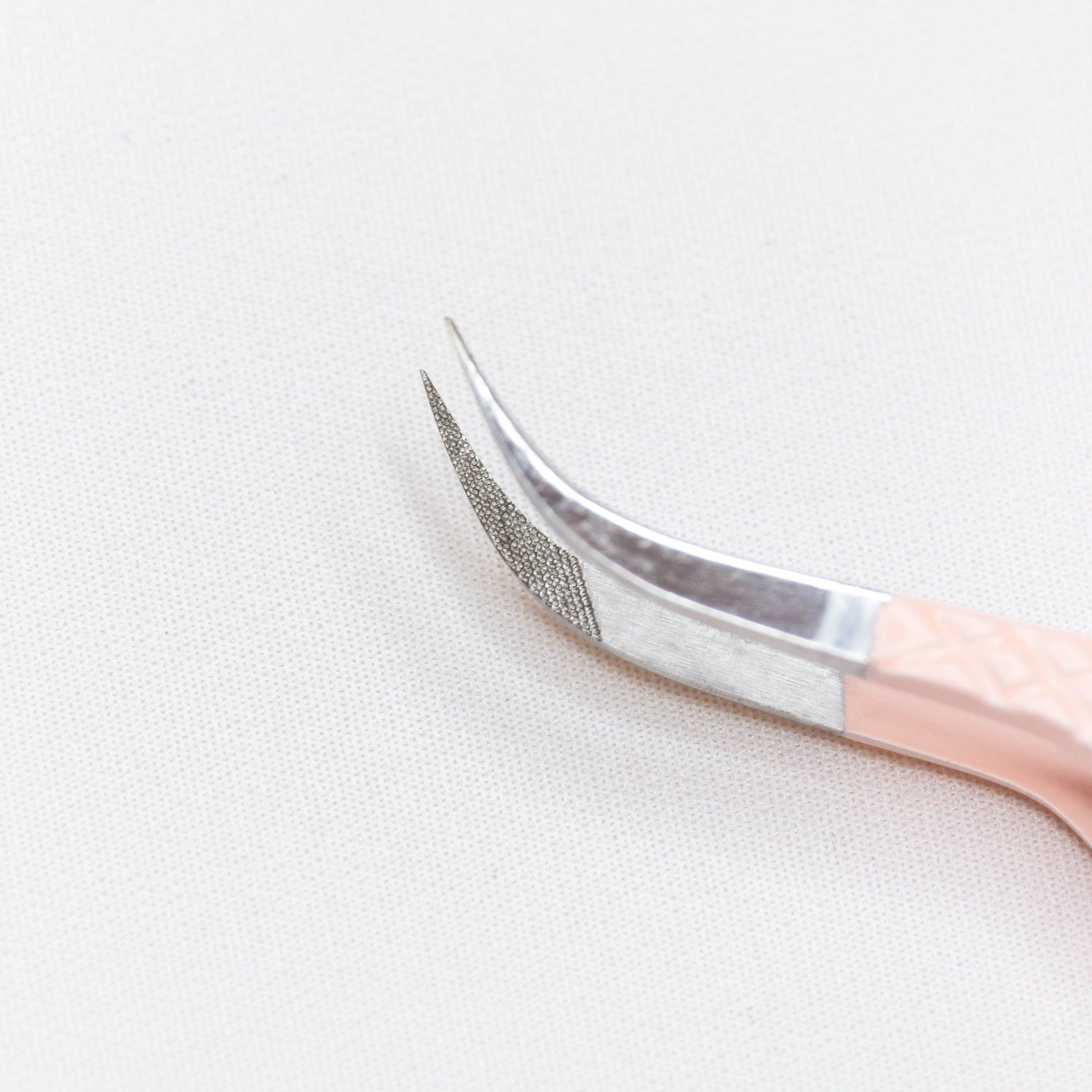 Close up of the curved tips of the Curved Blush Nano Tip Lash Tweezer