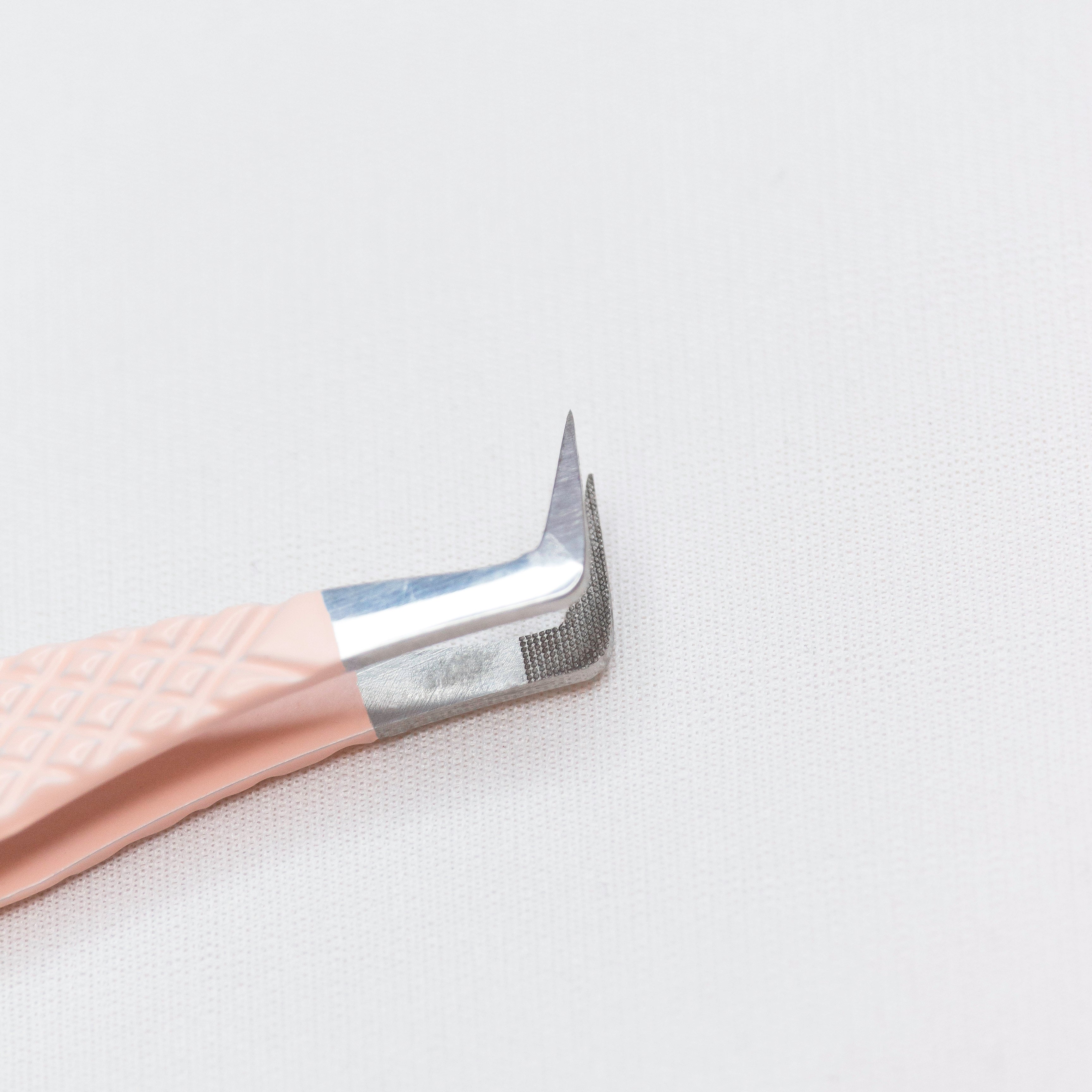 Close up of the laser etched tips of the Essential Blush Nano Tip Lash Tweezer. 