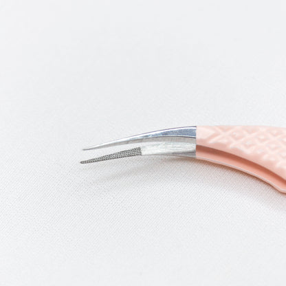 Close up of the moon curved tips of the Moon Curved Blush Nano Tip Lash Tweezer.