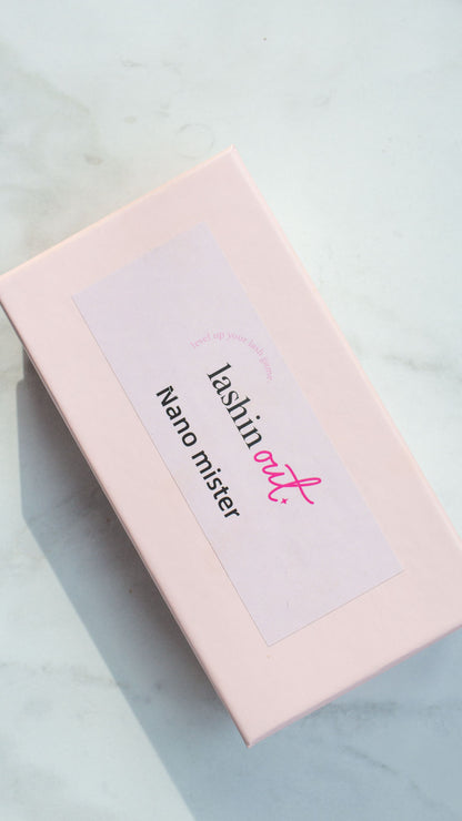 A pink box with a label that says Lashin Out in black and pink letters. Nano mister is written in black. 