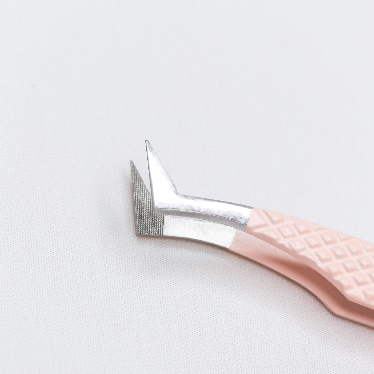 Close up view of the tips of the Square Foot Blush Nano Tip Lash Tweezer. The tips are at a 90 degree angle. 