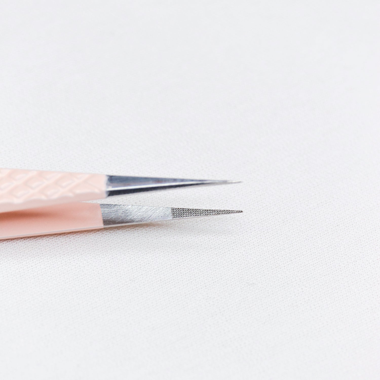 Close up view of the straight tips of the Straight Blush Nano Tip Lash Tweezer. 