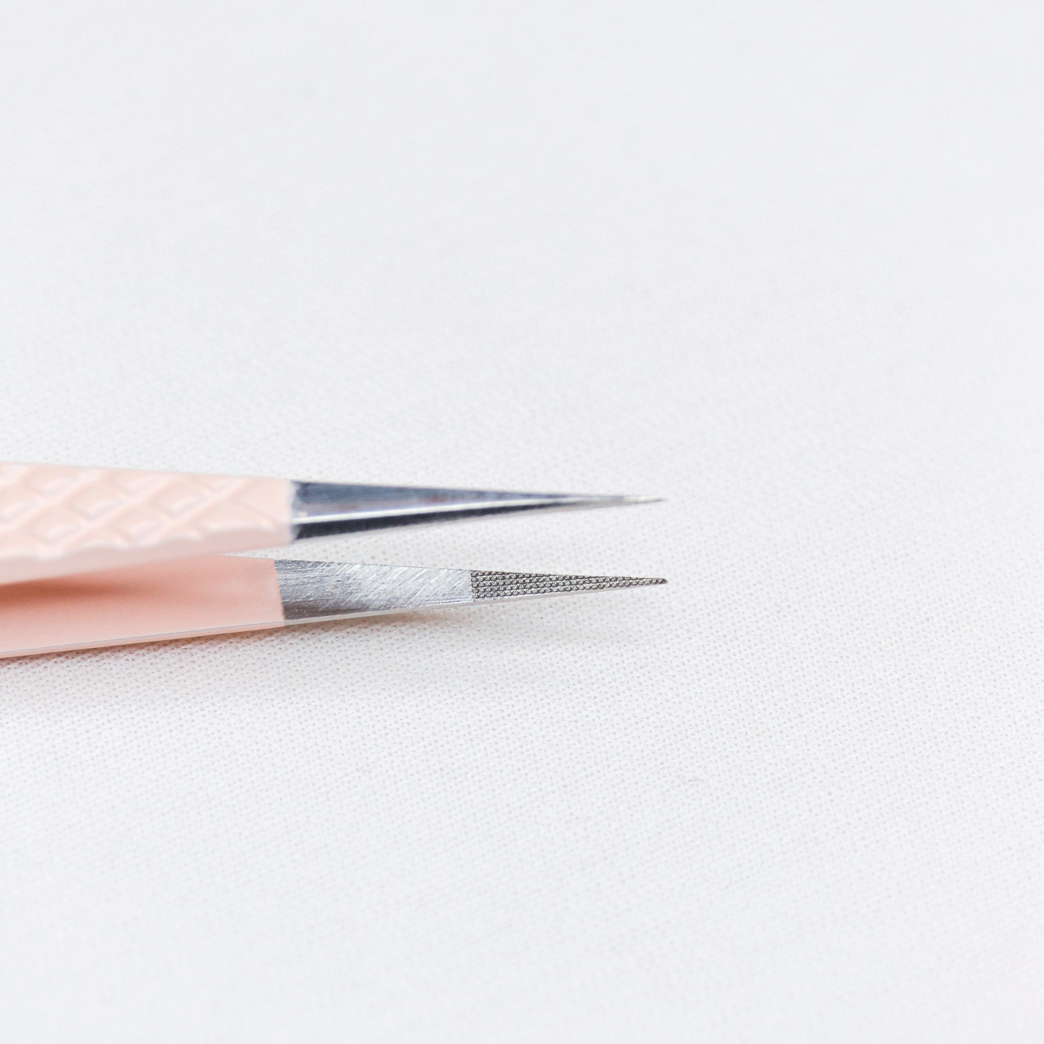 Close up view of the straight tips of the Straight Blush Nano Tip Lash Tweezer. 